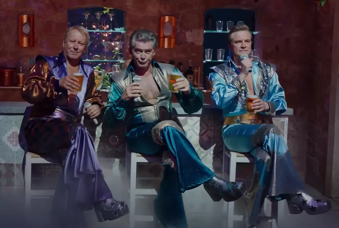 Stellan Skarsgård, Pierce Brosnan, and Colin Firth dressed in ridiculous 70s clothes.