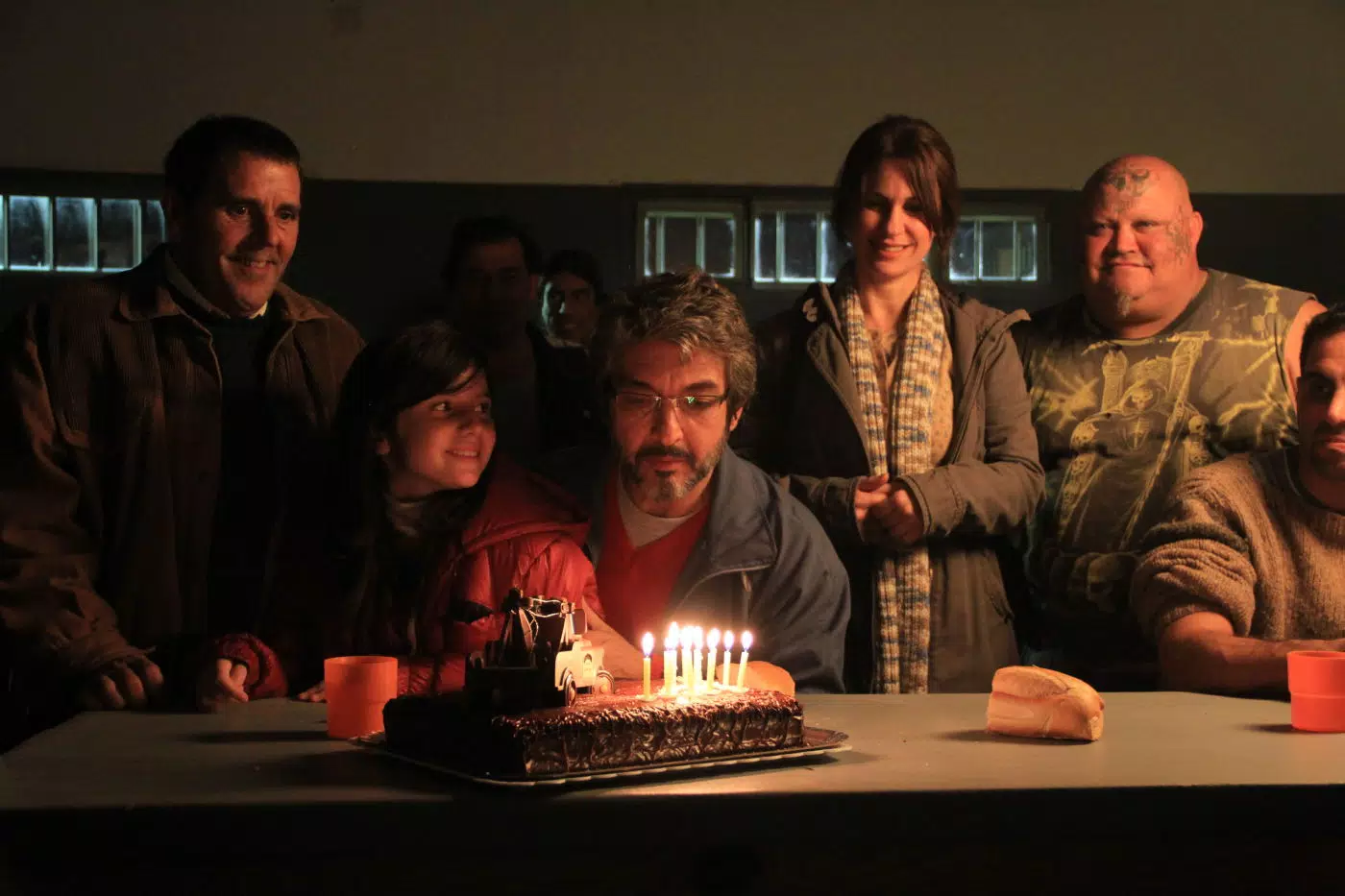 A man celebrating his birthday in prison with his family and prisonmates.