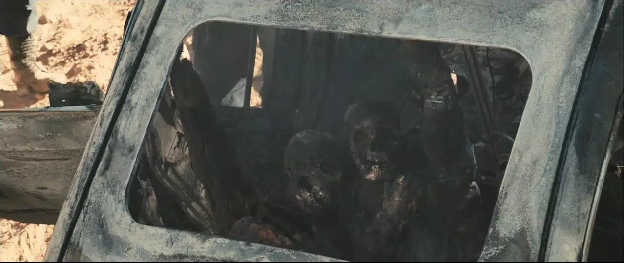 Two skeletons in the remains of a burnt car which appear to be embracing.