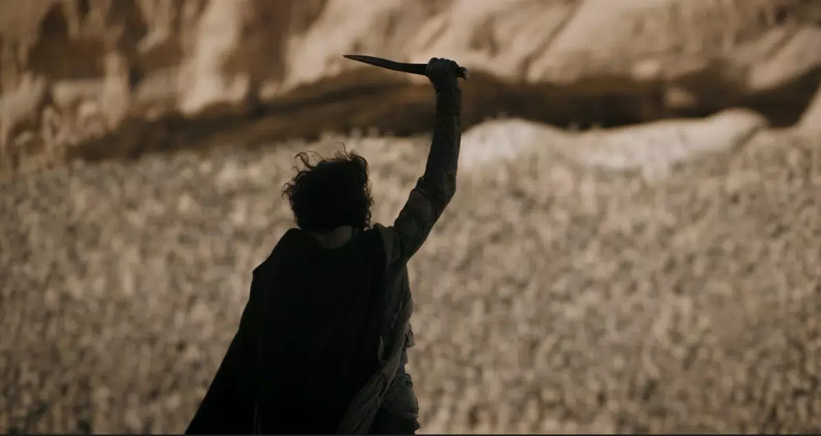 Paul raising his blade in front of his followers