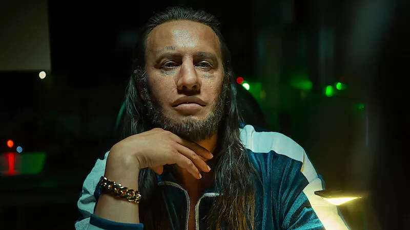 Karla Sofía Gascón portraying Juan Manitas in Emilia Pérez
