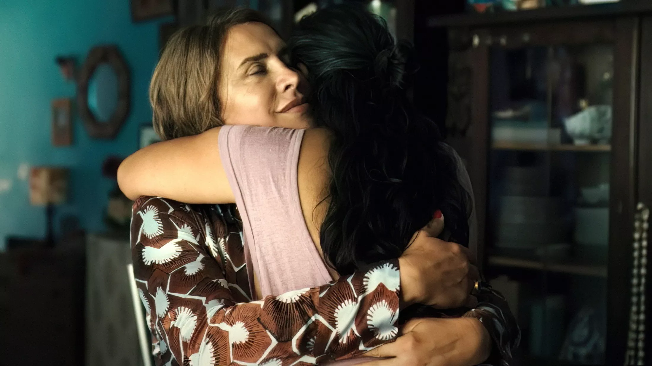 A still from Emilia Pérez. Emilia hugs another woman.