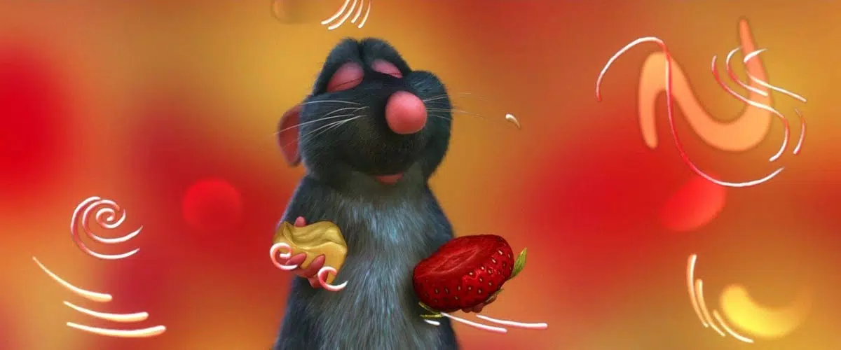 An animated rat holds cheese in one hand and a strawberry in the other. His eyes are closed