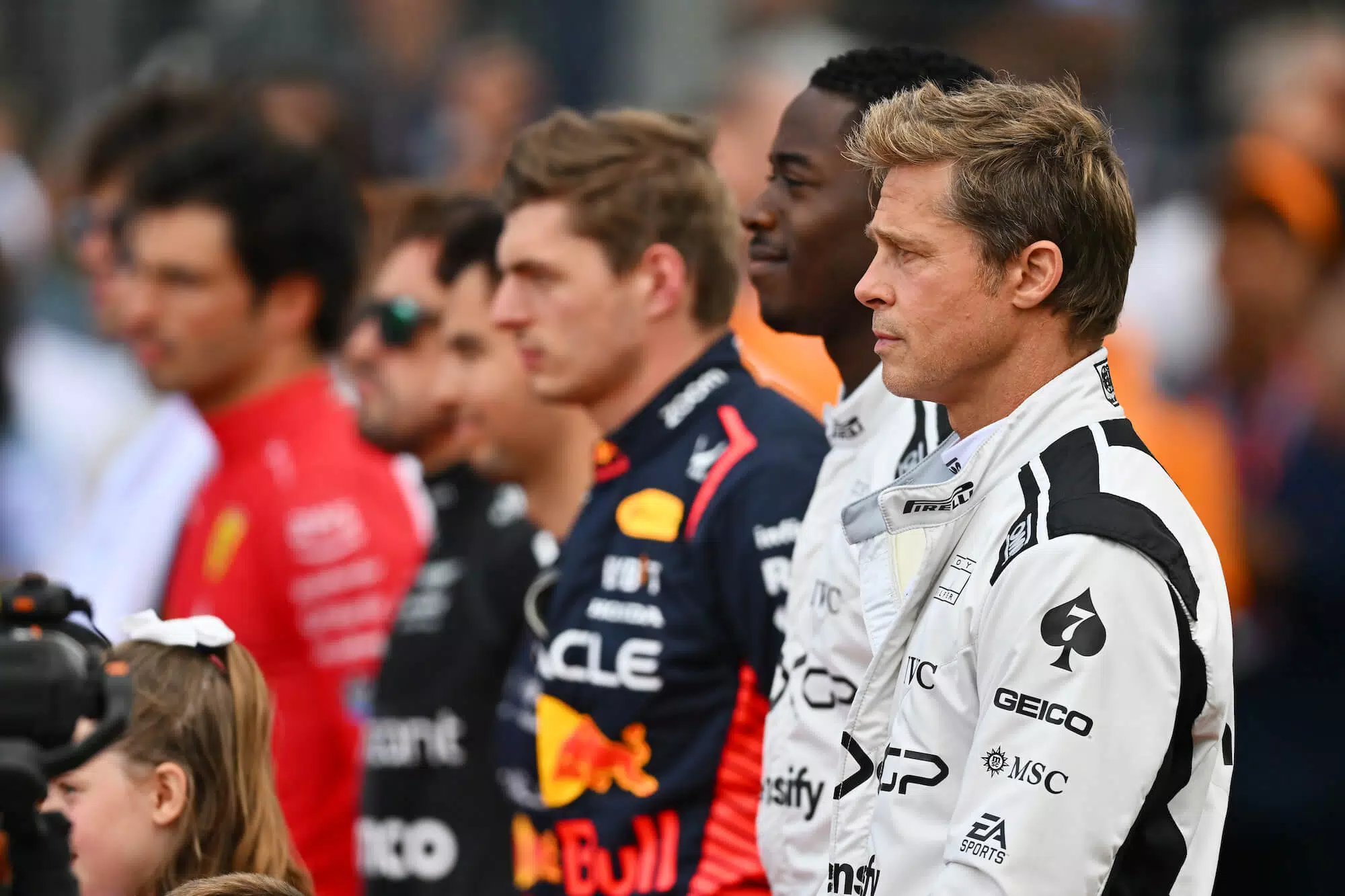 racing drivers standing in a row