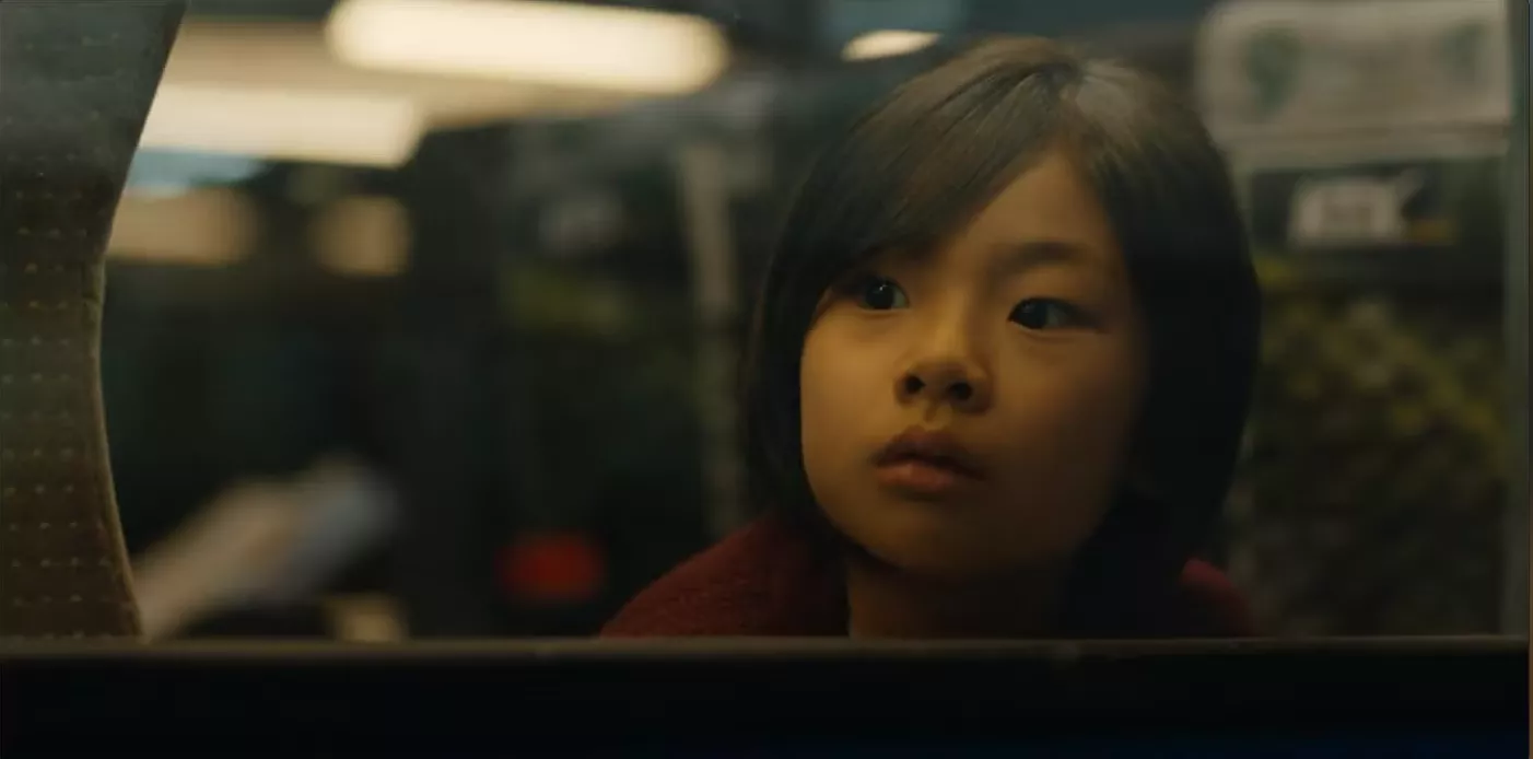 A young girl looking out a window