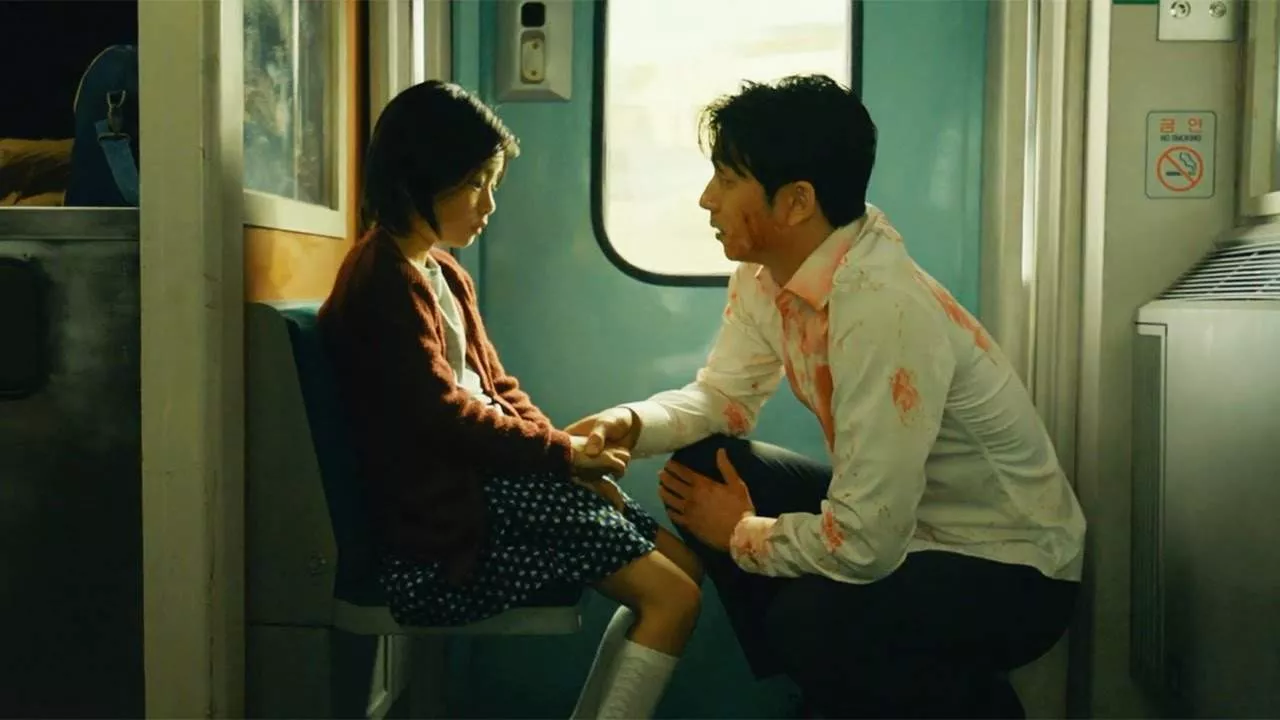 A father kneeling in front of his daughter