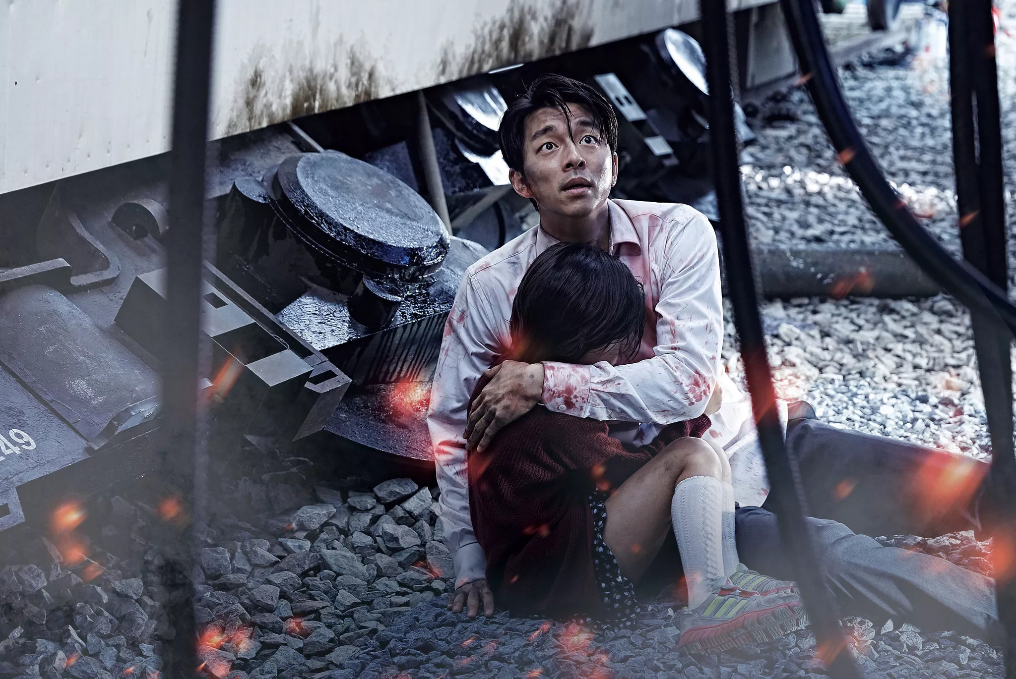 Father and daughter hugging amidst wreckage