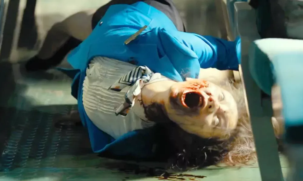 A female zombie contorting on the floor